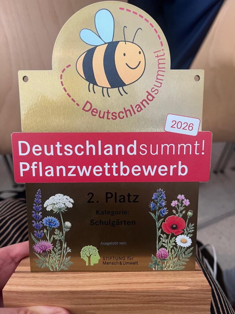 Der Pokal für den zweiten Sieger bei "Deutschland summt" mit der Aufschrift "Deutschlandsummt! Pflanzenwettbewerb. Bedruckt mit einer Biene und Pflanzen